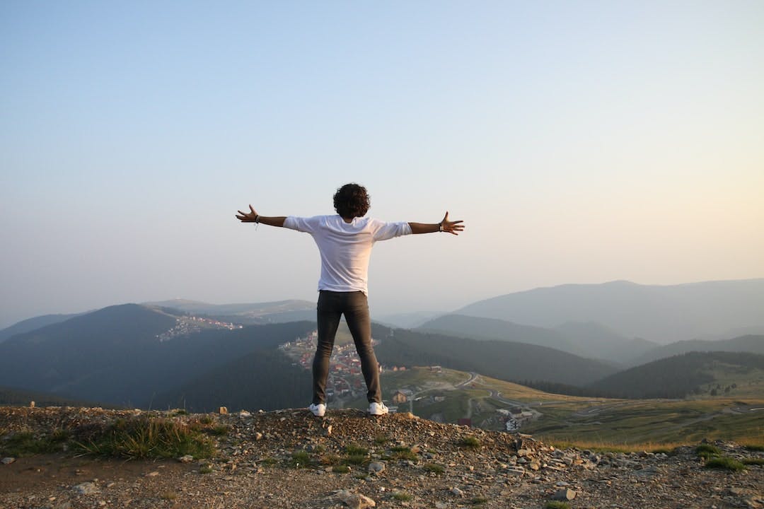 Young man on a top of a mountain